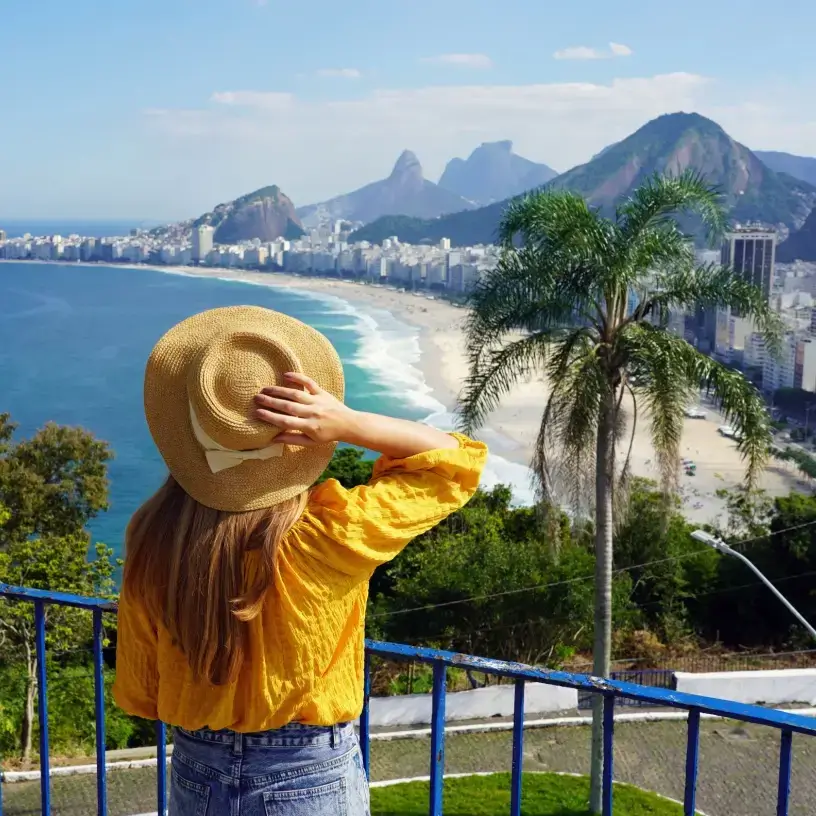Woman with travel insurance for Brazil overlooking the city of Rio